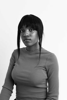 Elegant black and white portrait of a young woman with a neutral expression.