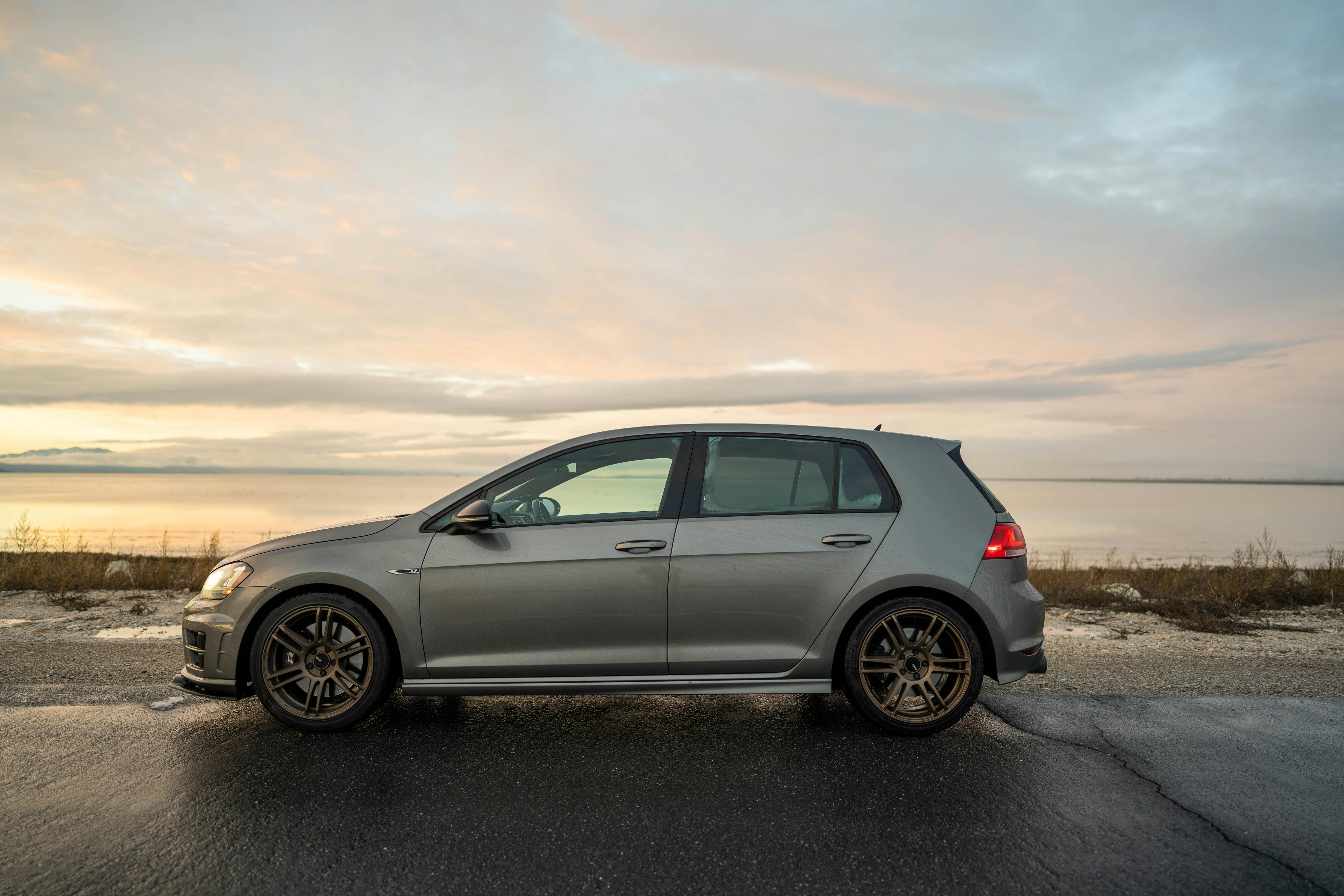 Silver Volkswagen Golf Mk7 on the Road by the Sea · Free Stock Photo