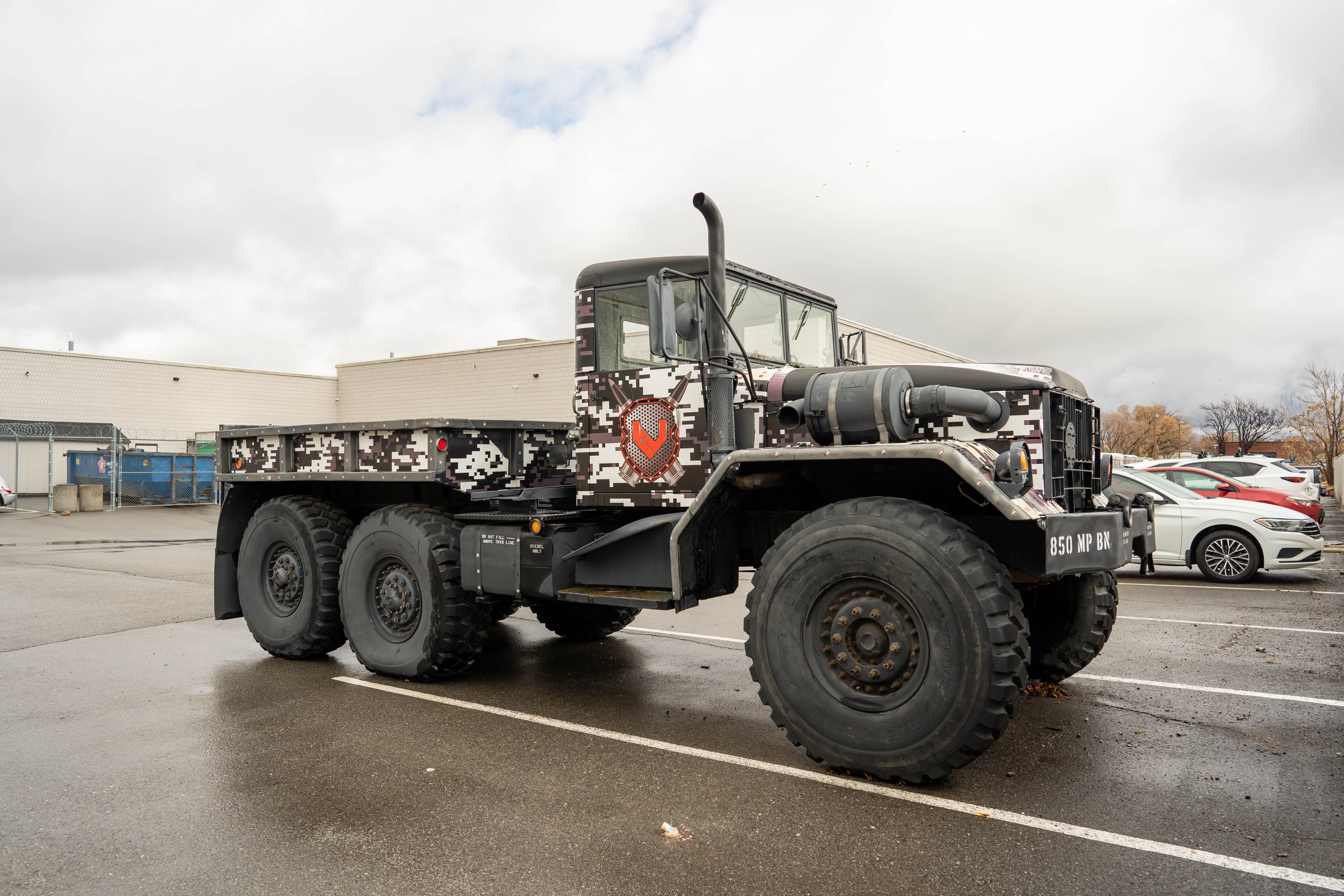A military truck with a camouflage paint job · Free Stock Photo