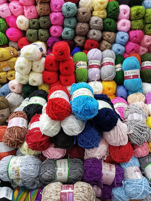 A pile of yarns and yarns in various colors