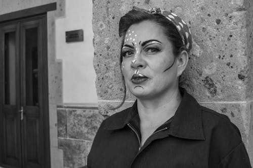 A woman with makeup on her face and a black and white photo