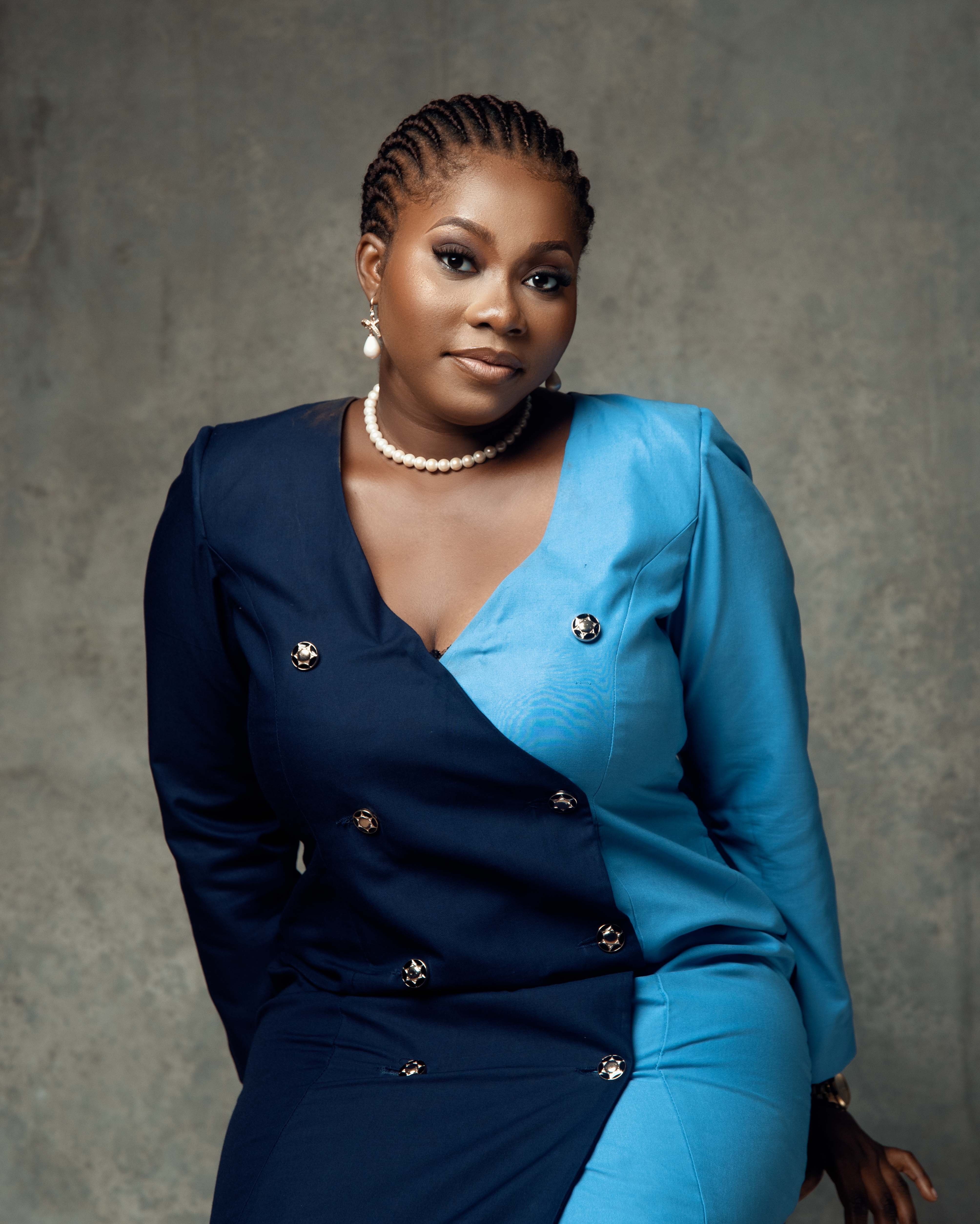 Elegant studio portrait of a woman in a stylish two-tone suit, exuding confidence and grace.