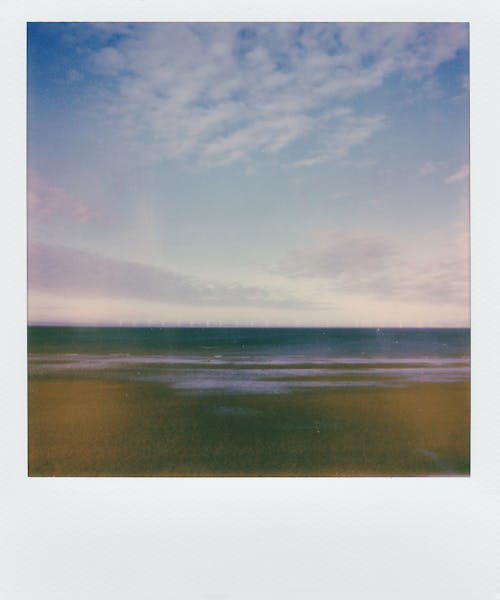 Body of Water Under Cloudy Sky