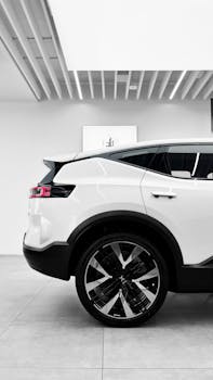 Side profile of a modern white SUV displayed at an auto exhibition in Dubai.