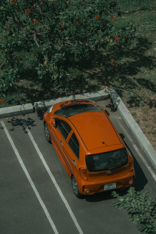 An orange car parked in a parking lot