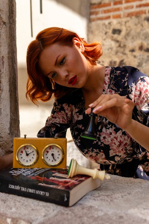 Young Woman Holding a King Chess Piece