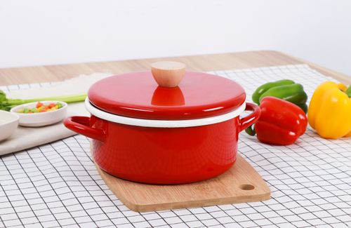 Free A vibrant red cooking pot with bell peppers on a checked table for a culinary setup. Stock Photo