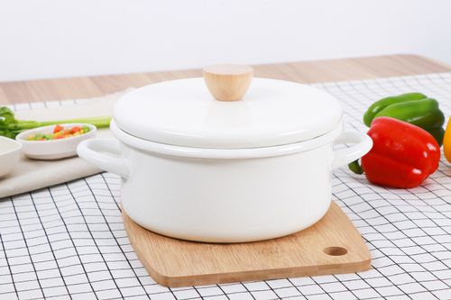 Free A white cooking pot with lid on a wooden cutting board, surrounded by fresh vegetables on a checkered cloth. Stock Photo