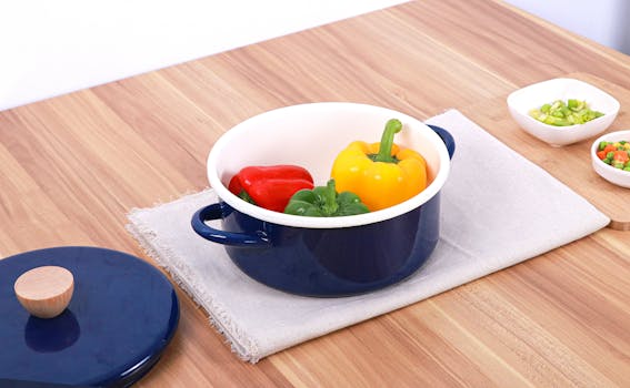 Colorful peppers in a blue pot on a wooden table, ideal for cooking and kitchenware themes.