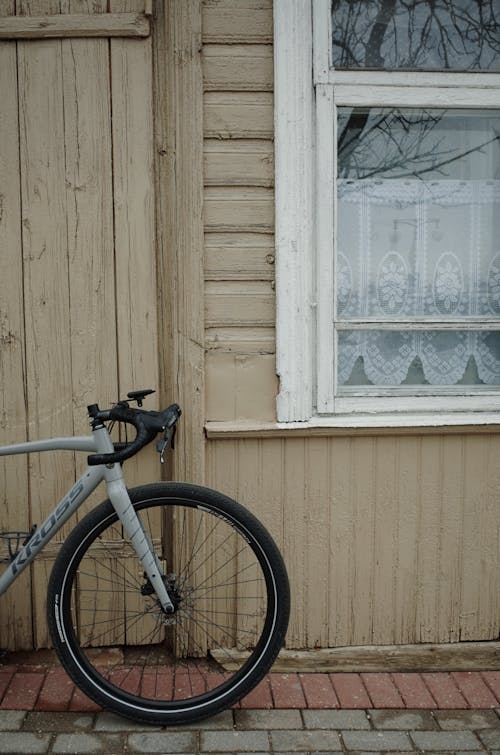 A bicycle leaning against a wooden door