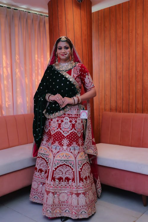 A woman in a red and black lehenga