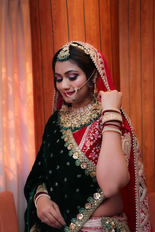 A beautiful indian bride in a green and red lehenga