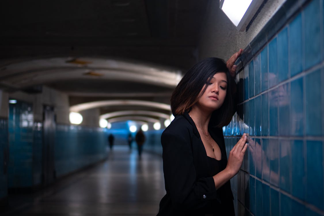 Woman Standing by Wall