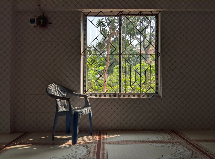 An empty chair in a quiet room with morning light through the window.