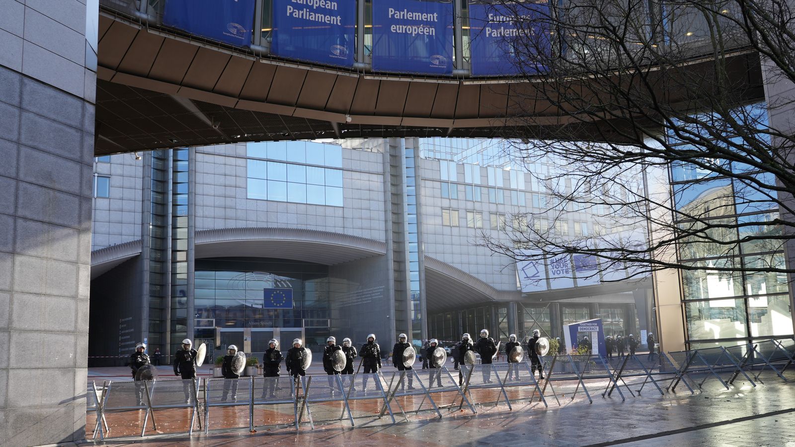 Police officers stand guard outside the European Parliament building in Brussels, Belgium.
