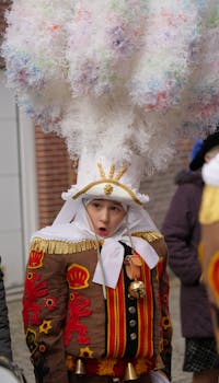 A child in a traditional Gilles costume participating in the Binche Carnival in Belgium, showcasing a cultural celebration.