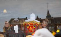 Reflection of people in Gilles costume at Binche Carnival, Belgium, showcasing cultural tradition.