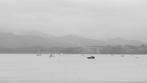 A black and white photo of boats in the water