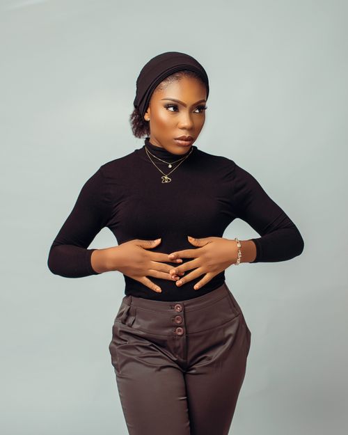 Free Chic studio portrait of a stylish young woman in black attire, posing elegantly. Stock Photo