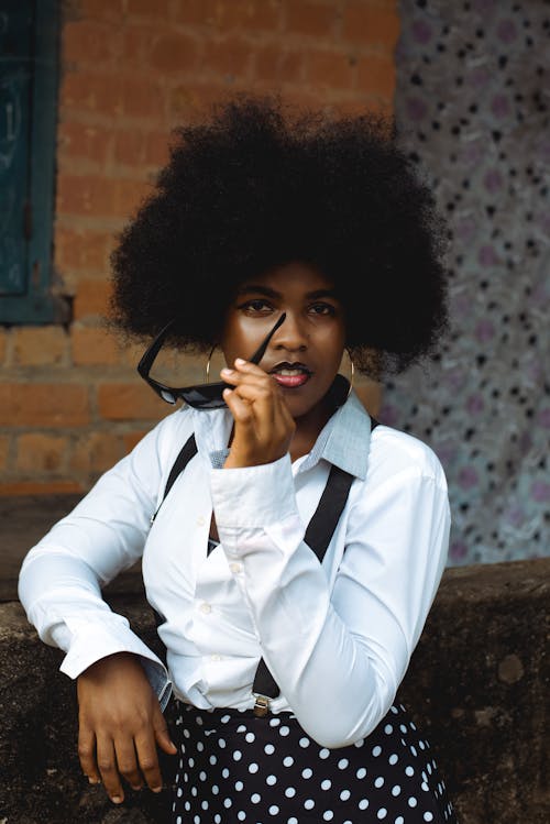 Portrait of Woman with Curly Hair and in White Shirt