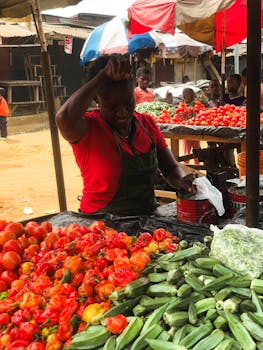 A lively vegetable market scene in Port Harcourt, Nigeria showcasing fresh produce.