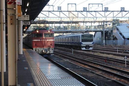 View of trains at Utsunomiya Station with tracks and platforms in Tochigi, Japan.