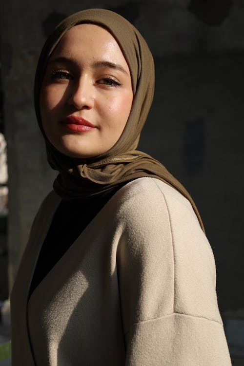A woman wearing a hijab and a black top