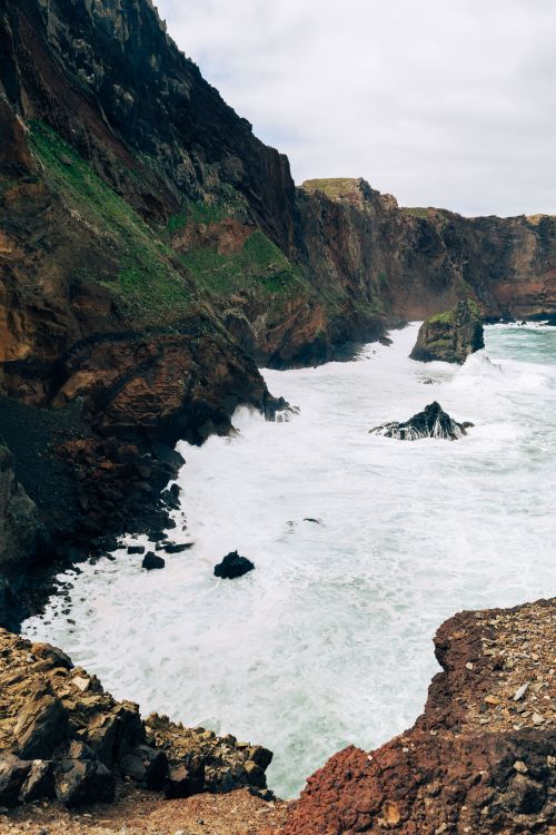 Free Breathtaking coastal scenery with rugged cliffs and rolling waves in Madeira, Portugal. Stock Photo