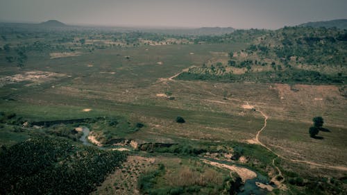 An aerial view of a field with a river