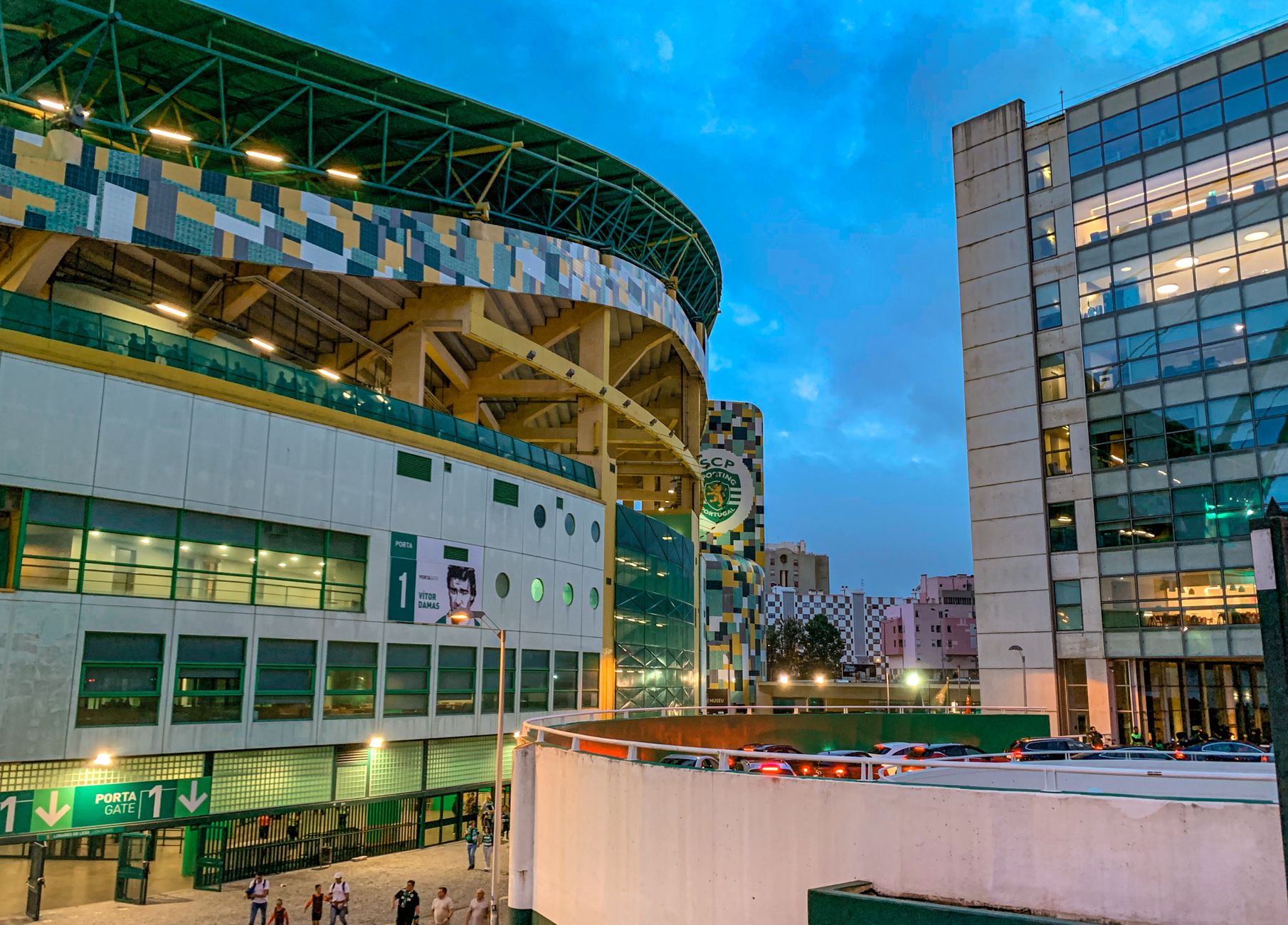Evening view of Estádio José Alvalade in Lisbon, Portugal, showcasing modern architecture and urban scenery.