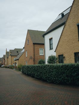 Quaint suburban street view with brick houses and greenery in Hoofddorp, Netherlands.
