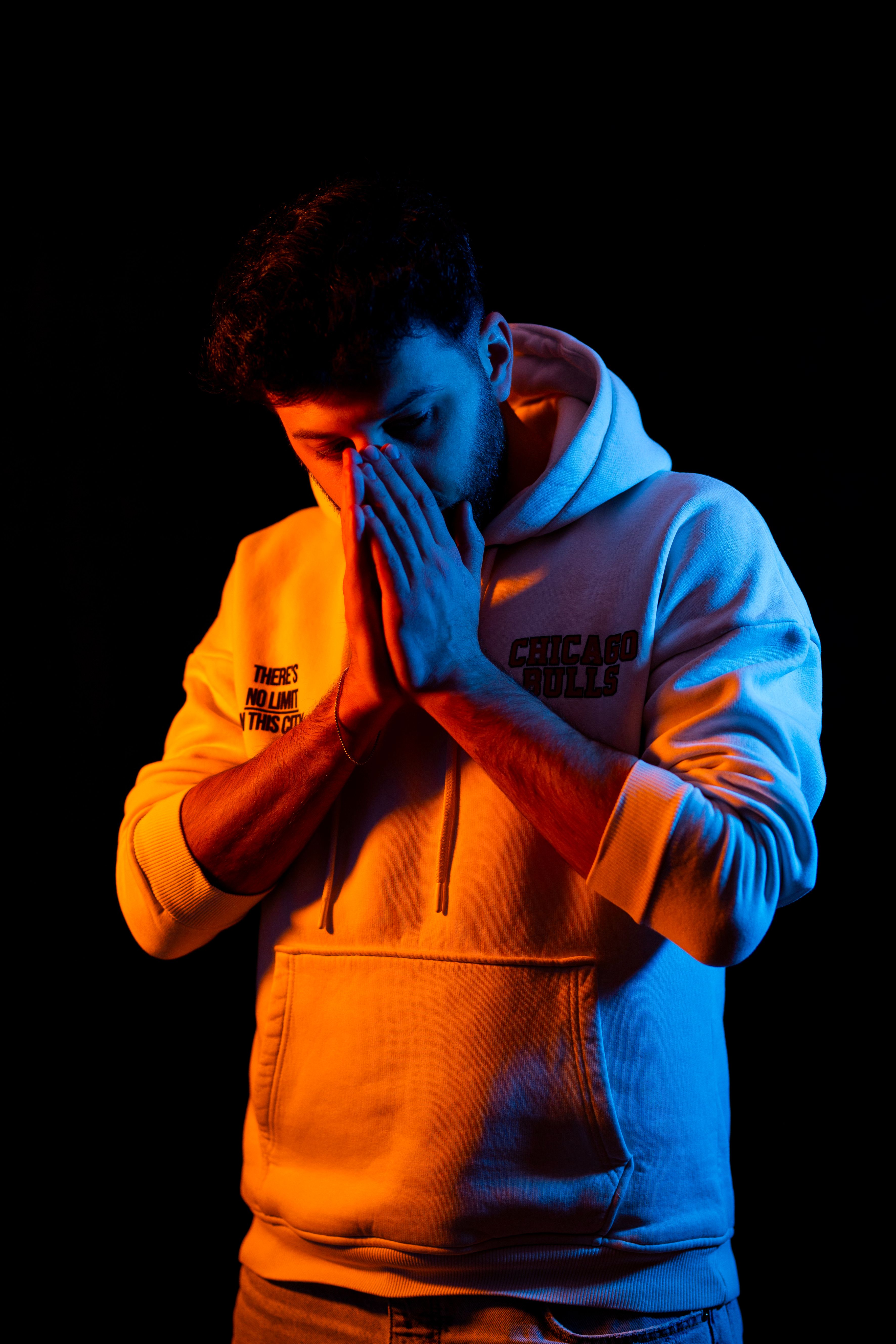 Studio Shot of a Man in a Hoodie Standing in Split Lighting · Free ...