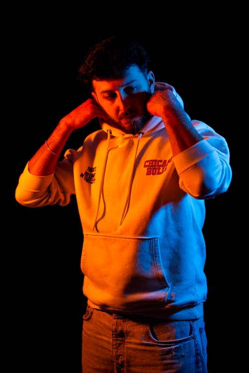 Studio Portrait of a Male Model Wearing a White Hoodie