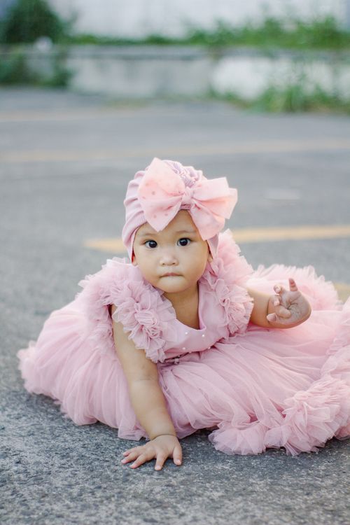 A Little Girl in a Pink Dress Sitting on the Ground Free Stock Photo A Little Girl in a Pink Dress Sitting on the Ground Free Stock Photo