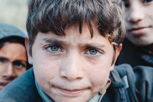 Free Close-up portrait of a young boy with expressive eyes in Faisalabad, Pakistan. Stock Photo