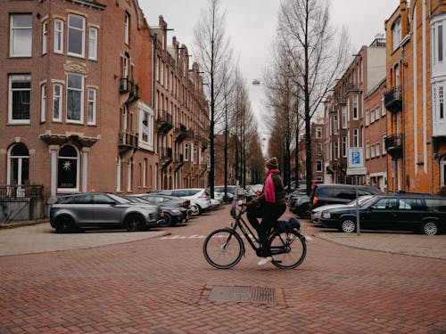 A person riding a bike on a brick street