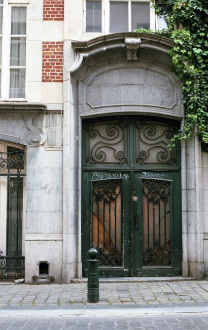 Elegant historical doorway with wrought iron details in Brussels, Belgium.