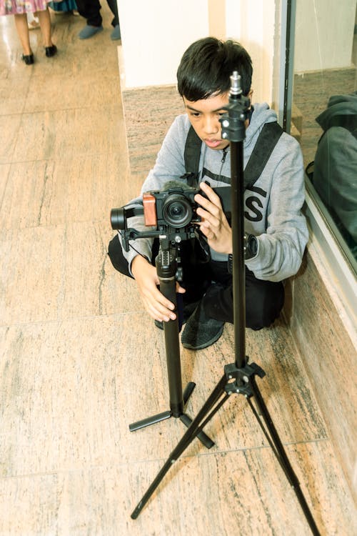 Young man Using a Camera on a Tripod