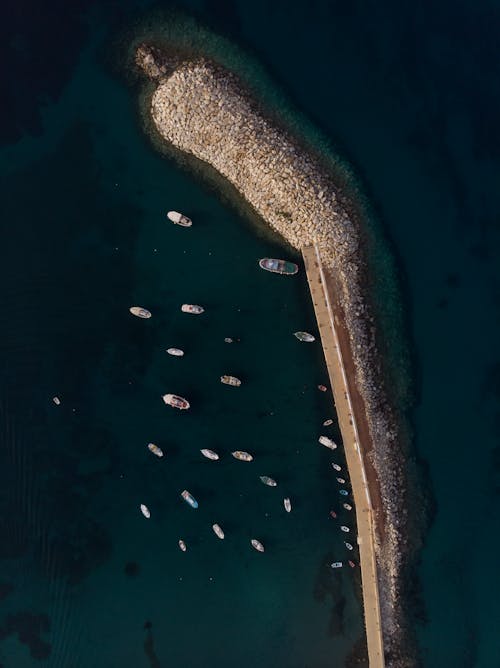 An aerial view of a pier with boats