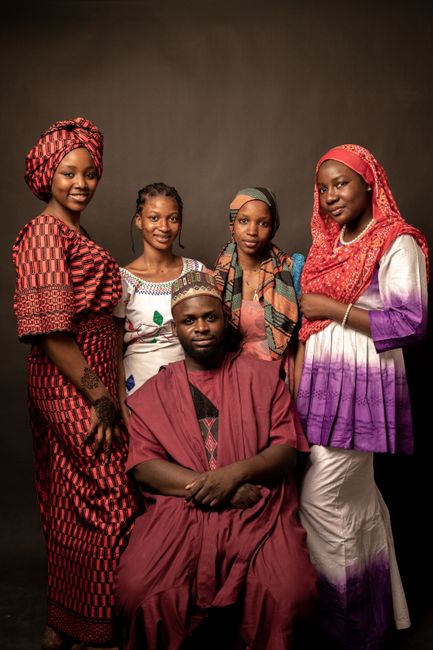 A family portrait showcasing vibrant traditional Nigerian attire and culture.