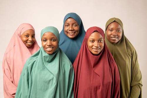 Four women wearing hijab are smiling for the camera