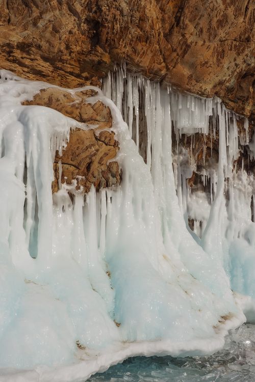 Free Explore breathtaking icicle formations in a rocky winter cave landscape. Stock Photo