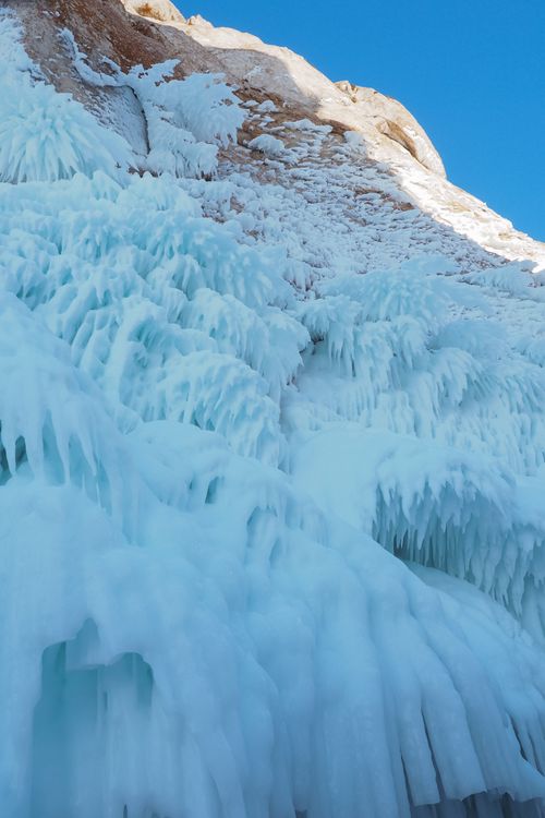 Free Majestic icy formations on Siberian cliffs under a clear blue sky, showcasing winter's beauty. Stock Photo