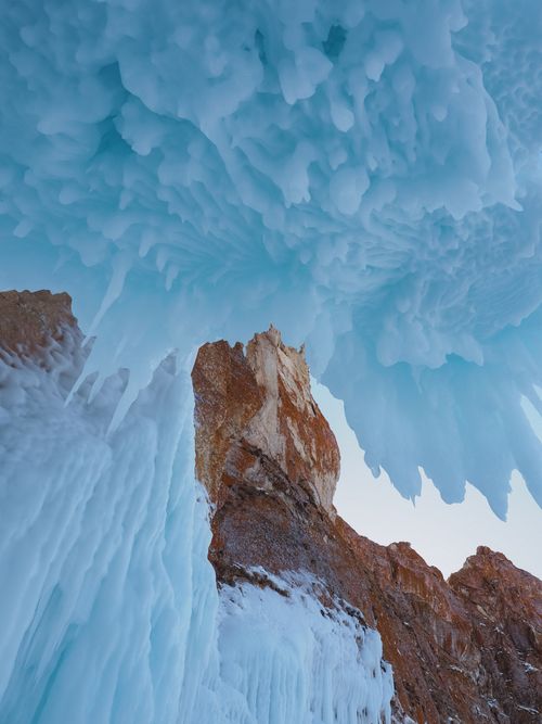 Free Majestic ice formations on rock cliffs depicting Siberian winter's harsh beauty. Stock Photo
