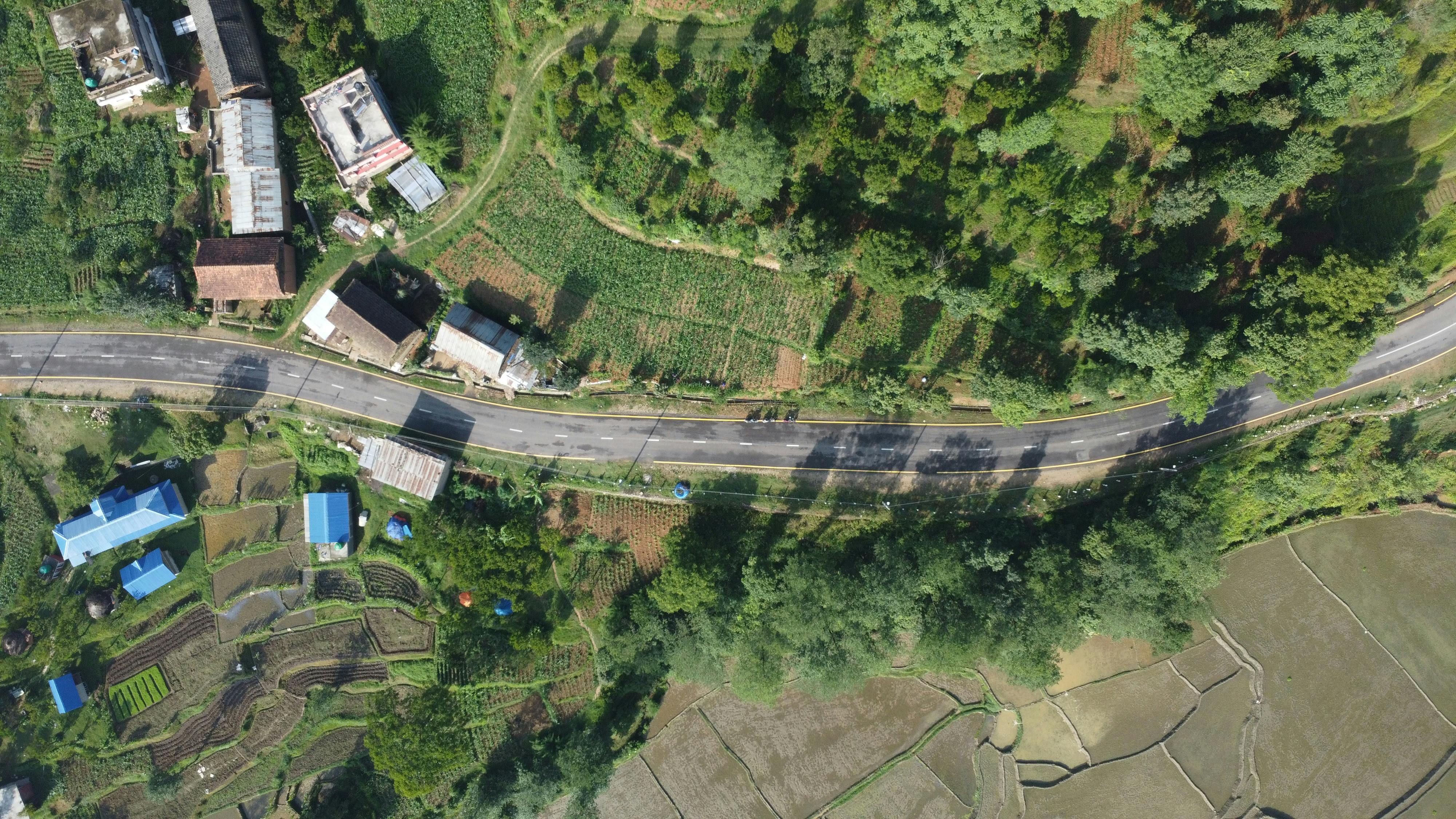 Drone shot capturing the lush countryside and farmland in Panauti, Nepal.