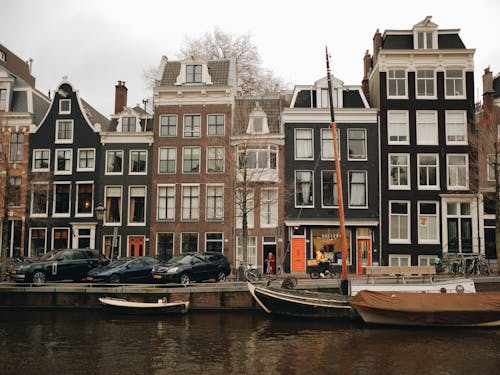 Cars Parked in Front of Townhouses on the Amsterdam Canal
