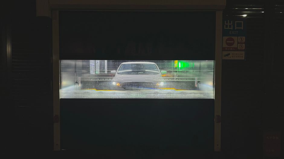 Car undergoing automatic wash in Tianjin, China, at night.