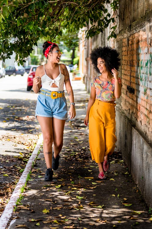 Two Women Laughing While Walking
