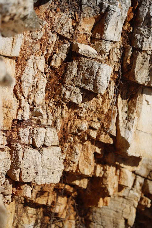 A close up of a rock wall with cracks