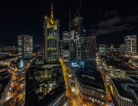 Stunning aerial night view of Frankfurt's illuminated skyline with skyscrapers.